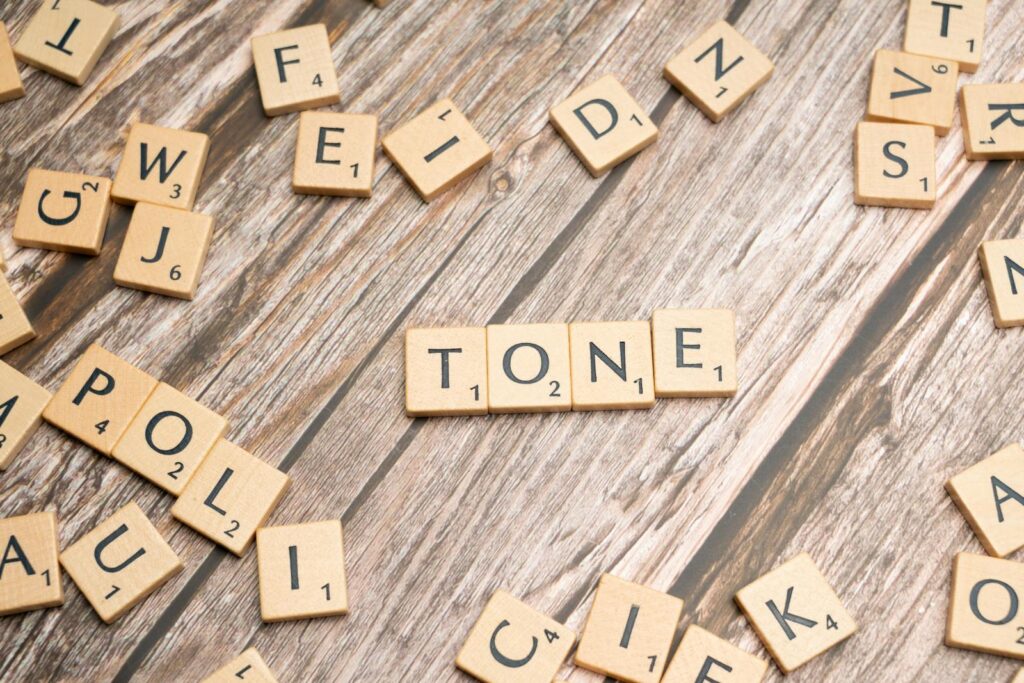 The word tone is spelled out in scrabble letters